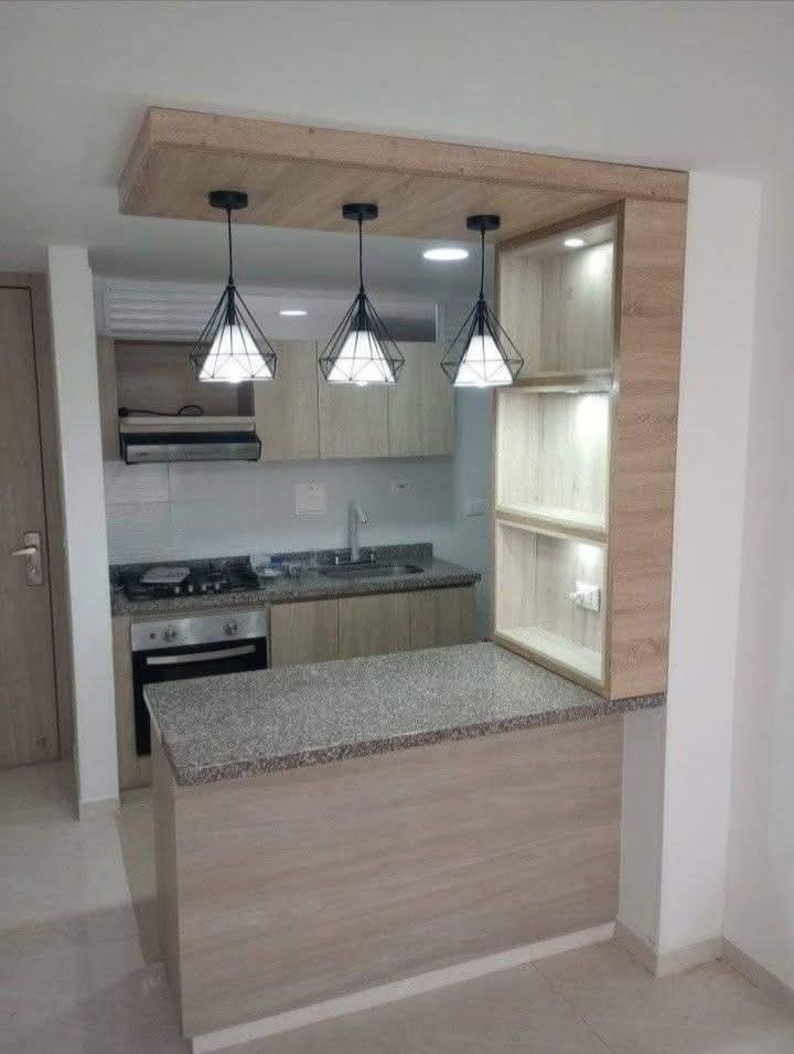 Cocina moderna con iluminación colgante tras reforma integral de vivienda en Madrid